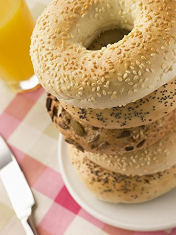Wallmonkeys FOT-8267830-30 WM210743 Stack of Seeded Bagels with a Glass of Orange Juice Peel and Stick Wall Decals (30 in H x 23 in W), Medium-Large